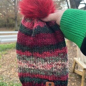 Hand knit beanie with a faux fur pom pom